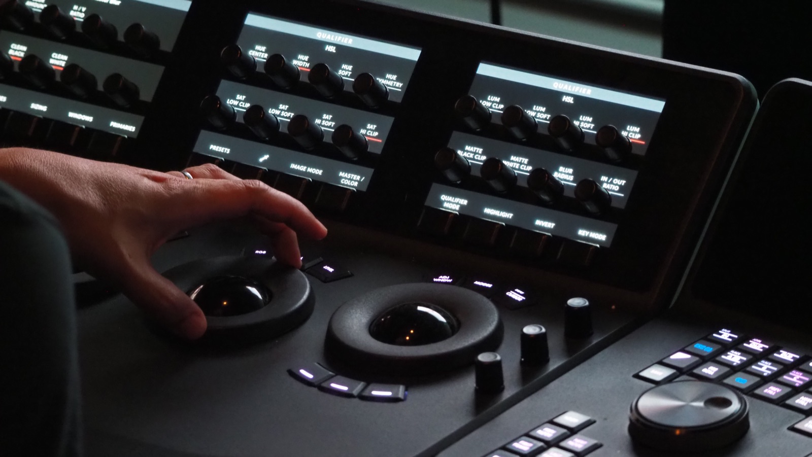 Colourist working a grading panel, HSL qualifier controls lit